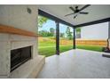 Back patio with brick fireplace and ceiling fan, great for enjoying the outdoors at 5350 Woodline View Cir, Hoschton, GA 30548