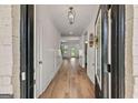 Bright foyer showcasing hardwood floors, white trim, and an open view to the living spaces at 5350 Woodline View Cir, Hoschton, GA 30548