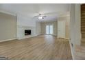 Spacious living room featuring a decorative fireplace, neutral tones, and updated flooring at 1201 Justin Ln, Lithonia, GA 30058