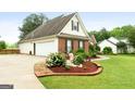 Lovely single-Gathering home with an attached garage, beautiful landscaping, and a well-maintained lawn at 235 Surrey Park Dr, Fayetteville, GA 30215