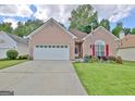 Charming brick home with a well-manicured lawn and vibrant flowerbeds enhancing curb appeal at 170 Habersham Dr, Fayetteville, GA 30214