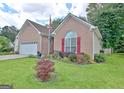 Charming brick home with a well-manicured lawn and vibrant flowerbeds enhancing curb appeal at 170 Habersham Dr, Fayetteville, GA 30214