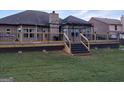 Spacious back deck with stairs leading to the yard, including a metal pergola for outdoor enjoyment at 1128 Carillon Se Dr, Conyers, GA 30013