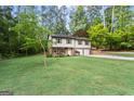 Beautiful two-story home with an attached two-car garage and a lush green lawn at 2687 Fairfield Sw Dr, Marietta, GA 30064