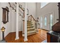 Elegant foyer with hardwood floors, a staircase, and a decorative front door with stained glass at 2810 Jodeco Ter, Jonesboro, GA 30236