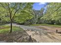 A long concrete driveway runs through a wooded lot with manicured landscaping at 120 Tall Pine Dr, Fayetteville, GA 30214