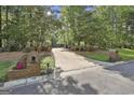 Long driveway approach to the property, brick entrance with house numbers and mature trees at 120 Tall Pine Dr, Fayetteville, GA 30214