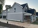 New home featuring a grey exterior, attached garage, and a covered side porch at 3189 Jackson, Hapeville, GA 30354