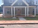 Charming new construction featuring a welcoming front porch and stylish, light pink front door at 3189 Jackson, Hapeville, GA 30354