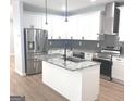 Bright kitchen featuring stainless appliances, granite counters and an island with sink at 3189 Jackson, Hapeville, GA 30354