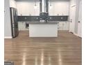 Modern kitchen featuring white cabinets, stainless steel appliances, and a center island at 3189 Jackson, Hapeville, GA 30354