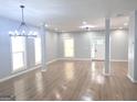 Bright and airy living room with modern chandelier, wood-look flooring, and plenty of natural light at 3189 Jackson, Hapeville, GA 30354