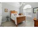 Cozy bedroom featuring vaulted ceilings, a large window, and a well-lit room, creating a serene atmosphere at 1152 Strath Clyde Way, Mcdonough, GA 30253