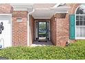 Inviting front entrance with brick facade, elegant glass door, and well-maintained landscaping provides great curb appeal at 1152 Strath Clyde Way, Mcdonough, GA 30253