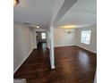 Open-concept living space with hardwood floors, neutral paint and stylish light fixtures at 590 Dot Dr, Atlanta, GA 30349