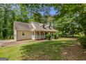 Traditional home with a well-kept lawn and covered front porch at 145 County Line Ct, Fayetteville, GA 30215