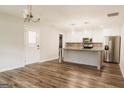 Bright kitchen featuring modern stainless steel appliances, stylish island, and updated cabinets at 8394 Banks Mill Rd, Douglasville, GA 30135