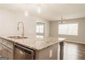 Close up on kitchen island with granite countertops and stainless steel dishwasher at 8394 Banks Mill Rd, Douglasville, GA 30135