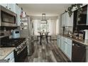 Well-lit kitchen featuring stainless steel appliances, light blue cabinets, granite countertops and a dining area at 228 Hunt Club Cir, Temple, GA 30179