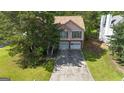 Aerial view showcasing a pink home with a long driveway, surrounded by lush greenery and mature trees at 300 Fox Trail Dr, South Fulton, GA 30349
