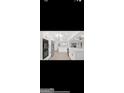 Spacious white kitchen boasts modern appliances, hardwood floors, and ample counter space at 4786 Carlene Sw Way # Iv, Lilburn, GA 30047