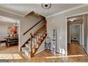 Inviting entryway with staircase, decorative sign, and hardwood flooring at 1486 Maple Ridge Dr, Suwanee, GA 30024