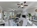 Spacious living room featuring a cozy brick fireplace and an abundance of natural light at 1486 Maple Ridge Dr, Suwanee, GA 30024