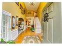 Bright foyer featuring hardwood floors, high ceilings, a staircase, and elegant decorative accents at 1373 Fall River Dr, Conyers, GA 30013