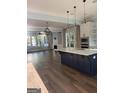 Spacious kitchen with a large island, modern appliances, and lots of natural light at 10583 Serenbe Ln, Palmetto, GA 30268