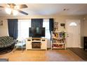 Cozy living room with a ceiling fan, large windows, and light colored carpet at 361 N Dogwood Ave, Social Circle, GA 30025