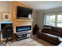 Cozy living room area with an electric fireplace and comfortable seating at 324 Bells Ferry Ne Rd, White, GA 30184
