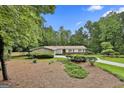 Charming single-story home with stone and siding, complemented by a lush, green front yard at 502 Pine Cir, Peachtree City, GA 30269