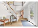 Bright foyer featuring hardwood floors, a staircase, and a decorative glass front door, creating a welcoming entrance at 2795 Hawthorne Dr, Atlanta, GA 30345