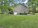 Brick home featuring attached garage and well maintained lawn at 120 Rolling Brook Trl, Fayetteville, GA 30215
