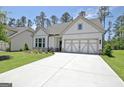 Inviting single-Gathering home showcasing a manicured lawn, decorative garage door, and concrete driveway at 82 Airmont Dr, Sharpsburg, GA 30277