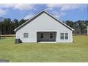 View of the back of the home with a covered patio and a spacious, newly sodded yard at 435 Cantrell Drive, Dallas, GA 30157