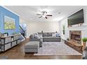 Comfortable living room with fireplace, neutral decor, and an adjacent staircase leading upstairs at 105 Turnberry Trce, Sharpsburg, GA 30277
