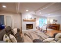Bright living area with a stone fireplace, plush seating, and a charming piano ideal for entertaining guests at 170 River Forest Dr, Fayetteville, GA 30214