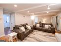 Cozy living room featuring hardwood floors, comfortable leather sofas, and decorative pillows perfect for Gathering gathering at 170 River Forest Dr, Fayetteville, GA 30214