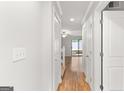 Bright hallway with hardwood floors leading to a living room and outdoor deck at 53 Cobblestone Crk, Peachtree City, GA 30269