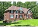 Traditional brick home featuring manicured landscaping and a well-maintained lawn at 20 Allie Dr, Mcdonough, GA 30252
