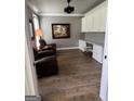 Home office featuring a built-in desk, ample storage and hardwood floors at 1122 Montclair Dr, Peachtree City, GA 30269