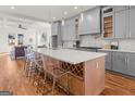 Modern kitchen island with a white countertop, wine rack, and seating for a perfect gathering space at 2018 Presley, Atlanta, GA 30317