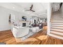 Open-concept living room with hardwood floors, fireplace, and contemporary furnishings at 2018 Presley, Atlanta, GA 30317