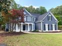 Attractive two-story home with a welcoming front porch and well-maintained landscaping at 219 Maple Creek Chase, Woodstock, GA 30188