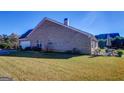Expansive backyard features a well-kept lawn and patio area with outdoor dining furniture at 3008 Brighton Ct, Conyers, GA 30094