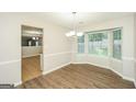 Bright dining room featuring elegant chandelier, large windows, and modern flooring, perfect for Gathering meals at 3587 Oakvale Ave, Decatur, GA 30034