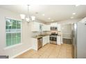 Well-lit kitchen with stainless steel appliances, tile flooring, and ample counter space for culinary enthusiasts at 3587 Oakvale Ave, Decatur, GA 30034