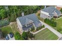Aerial view of the luxurious home, showing the roof, landscaping, and part of the driveway at 2750 Brentwood Estates Ct, Cumming, GA 30041