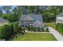 Beautiful two-story brick home featuring manicured landscaping and a well-maintained lawn at 2750 Brentwood Estates Ct, Cumming, GA 30041